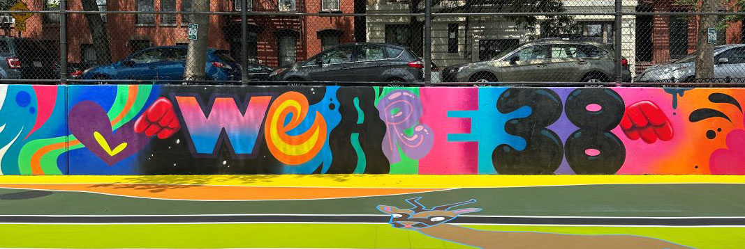 A graffiti wall that says 'We are 38' in bright colors.